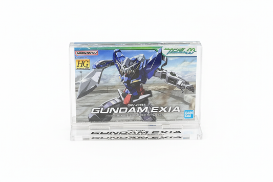 Gundam Base PakeColle HG 1/144 Gundam Exia acrylic display stand featuring box art design - angled view on white background
